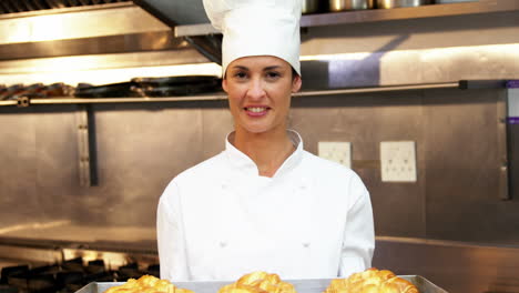 Chef-showing-tray-of-croissants