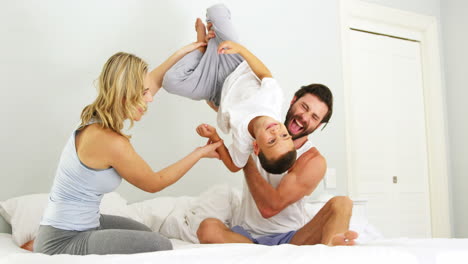 Happy-family-playing-together-on-a-bed