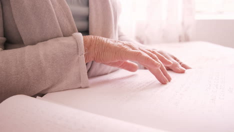 Senior-blind-man-reading-a-braille-book