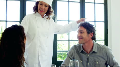 Chef-explaining-something-to-couple