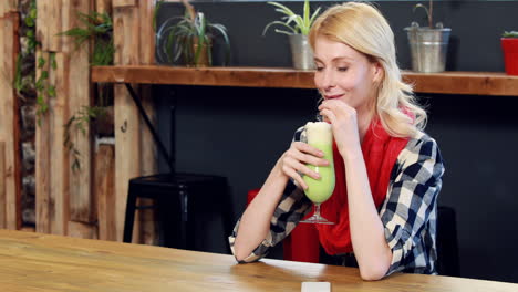 Woman-drinking-green-milkshake