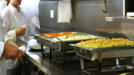 Chefs-at-serving-trays-of-pasta