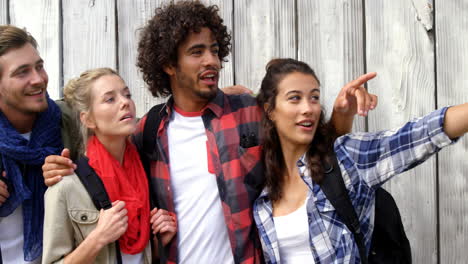 Group-of-friends-standing-with-woman-pointing-hand-upward