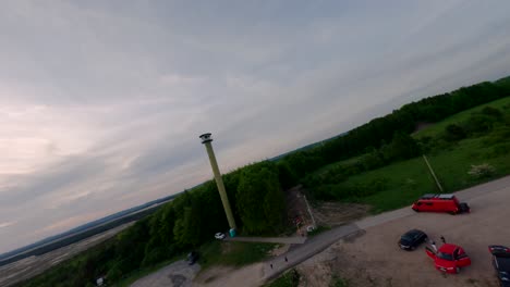 Observation-platform-and-tower-over-Bledowska-Desert-in-Poland,-aerial-FPV-orbit