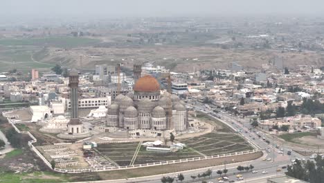 Drone-footage-captures-the-majestic-Great-Mosque-of-al-Nuri-in-Mosul,-Iraq,-showcasing-its-iconic-leaning-minaret-and-historic-beauty