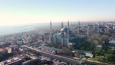 Aerial-footage-showcasing-the-iconic-Blue-Mosque-in-Istanbul,-Turkey,-with-its-majestic-domes,-minarets,-surrounded-by-the-cityscape-and-historic-landmarks