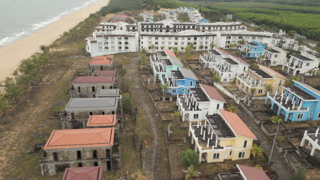 Abandoned-Resort-Villas-Sit-Empty-On-The-Sand-Dunes-Of-Lang-Co-Beach-Vietnam-60FPS