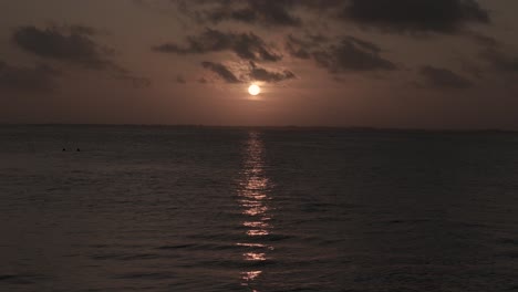 Peaceful-tropical-golden-hour-sunset-glowing-over-Michamvi-Kae-shimmering-Indian-ocean,-Zanzibar