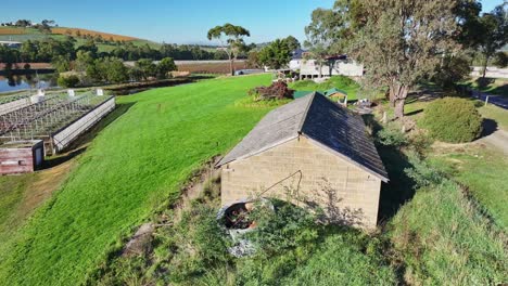 Aerial-over-an-old-storage-building-on-a-vineyard-in-the-Yarra-Valley-near-Yarra-Glen-in-Victoria-Australia