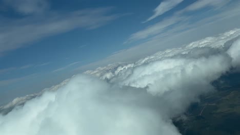 Immersive-pilot-POV-flying-over-some-clouds-doing-some-turns-to-avoid-them