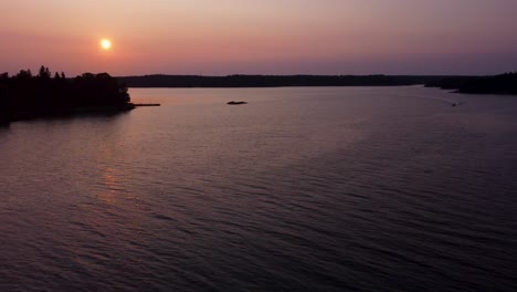 Vibrant-sunset-over-Stockholm-Archipelago-and-calm-Baltic-Sea,-aerial-view