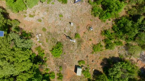 Slow-aerial-spinning-shot-of-a-gap-in-the-forest-in-Puéchabon-with-solar-panels