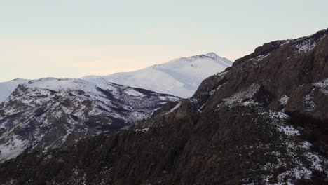 Zoom-in-on-snowy-mountain-and-rocky-ridge-near-El-Chalten,-Patagonia,-Argentina