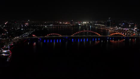 Aerial-night-view-of-the-Da-Nang-Dragon-Bridge-in-Vietnam,-Saigon