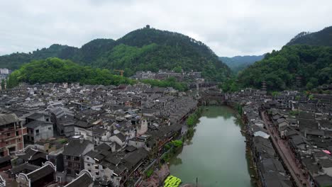 Fenghuang-Old-Town-with-Rainbow-Bridge-and-Wanming-Pagoda-by-mountains-and-Tuo-Riang-river