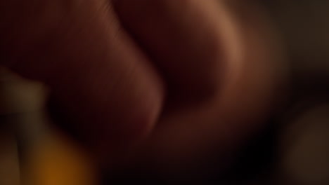 Extreme-closeup-on-right-hand-strumming-chords-of-an-acoustic-guitar