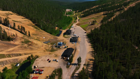 Aerial-view-tilting-away-from-the-bottom-of-Saariselka-slopes,-summer-in-Lapland