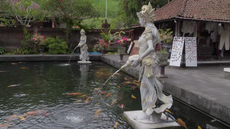 Beautiful-statues-at-Pura-Gunung-Kawi-Sebatu-temple-in-Bali,-overlooking-a-koi-pond