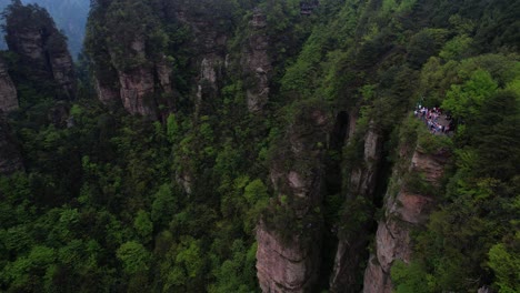 Tourists-visit-viewpoint-at-Huangshi-Village-for-impressive-view-over-forested-pillars