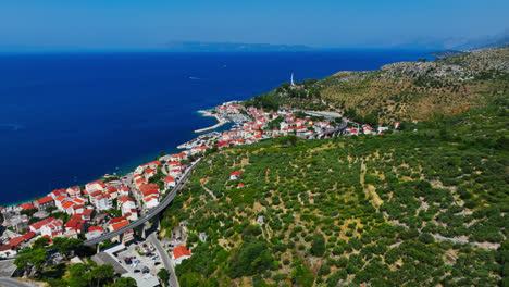 Aerial-overview-of-the-Podgora-town,-sunny-day-in-Makarska-riviera,-Croatia