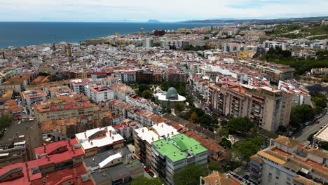Cityscape-of-Estepona-with-seascape-in-horizon,-aerial-drone-view