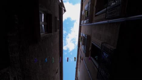 Slow-dolly-shot-down-the-streets-in-Pezenas-with-bunting-decorations-hanging