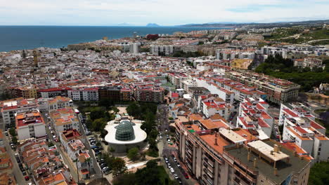 Cityscape-buildings-of-Estepona-and-seascape-in-horizon,-aerial-view