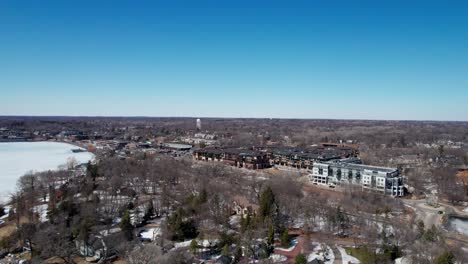 Drone-aerial-view-of-downtown-Wayzata,-Minnesota-condos-and-businesses