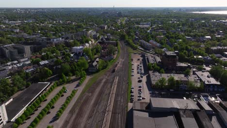 Aerial-Tracking-Shot-Above-Train-Leaving-Tallinn,-Estonia---Baltic-Train-Station