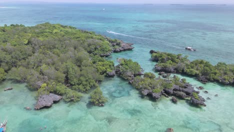 Boats-passing-secluded-turquoise-blue-Kwale-Island-lagoon-in-Zanzibar