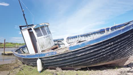 Old-wooden-fishing-boat-abandoned-on-tidal-mudflats-River-Blyth-marina