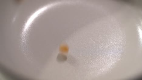 Closeup-footage-of-raw-popcorn-in-slow-motion