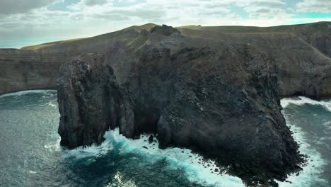 Famous-El-Boiler-dive-site-off-coastline-of-volcanic-San-Benedicto-island,-aerial-dolly