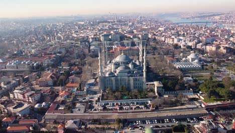 Aerial-footage-showcasing-the-iconic-Blue-Mosque-in-Istanbul,-Turkey,-with-its-majestic-domes,-minarets,-surrounded-by-the-cityscape-and-historic-landmarks