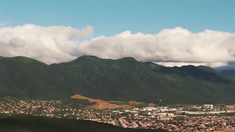 Distant-aerial-drone-view-of-Salta,-Argentina,-mountains-in-background