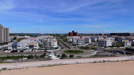 An-aerial-view-over-a-traffic-circle-in-Queens,-New-York-on-a-sunny-day-with-blue-skies