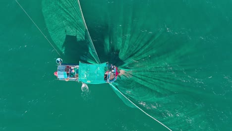 Drone-view-a-fishing-boat-is-netting-fishes-on-Tuy-Hoa-sea,-Phu-Yen-province,-central-Vietnam