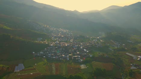 Aerial-view-of-an-Indonesian-rural-village-in-the-mountains-during-sunrise