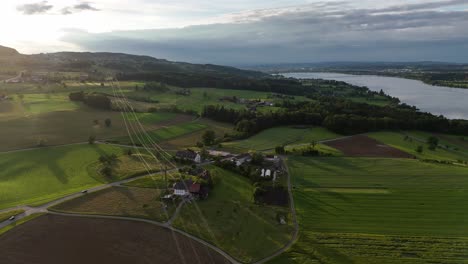 Greifensee-in-switzerland-with-lush-fields-and-a-serene-lake,-aerial-view