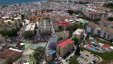 Colorful-rooftops-of-Estepona-city-apartment-buildings,-high-angle-drone-view