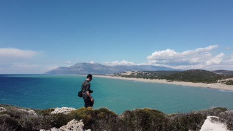 Solo-Tourist-Man-Walks-Thru-Beach-Facing-Ancient-Patara-on-the-Turkish-coast