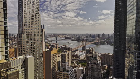 NYC-New-York-Aerial-v403-drone-fly-through-Lower-Manhattan's-financial-district,-capturing-two-bridges-over-the-East-river-and-Brooklyn-cityscape-skyline---Shot-with-Mavic-3-Pro-Cine---September-2023