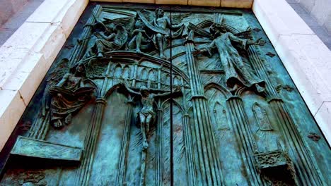 close-up-zoom-over-details-on-bronze-church-door-of-Catedral-De-La-Almudena-in-Madrid