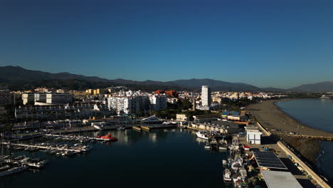 Marina-and-city-skyline-of-Estepona-city,-aerial-view