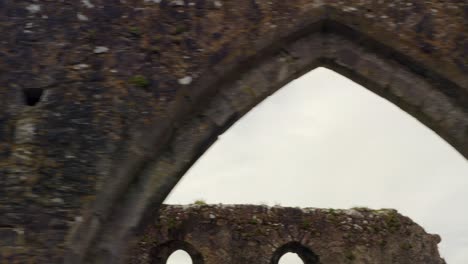 Close-up-descend-across-Claregalway-Friary-weathered-arches-and-broken-walls