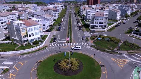 An-aerial-view-over-a-traffic-circle-in-Queens,-New-York-on-a-sunny-day-with-blue-skies