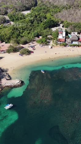 Aerial-view-of-the-coral-reefs-off-the-coast-of-Huatulco,-Oaxaca,-Mexico,-in-vertical-mode