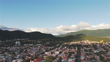 Drone-Orbit-over-Salta,-contrasting-mountains-and-clouds