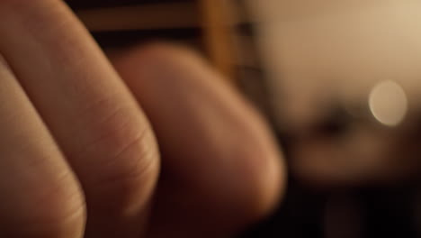 Close-up-of-fingers-playing-chords-on-an-acoustic-guitar