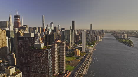 NYC-New-York-Aerial-v399-flyover-East-river-capturing-Freedom-Plaza-in-Murray-Hill-and-Midtown-East-Manhattan-cityscape,-sunlight-glowing-on-the-buildings---Shot-with-Mavic-3-Pro-Cine---September-2023